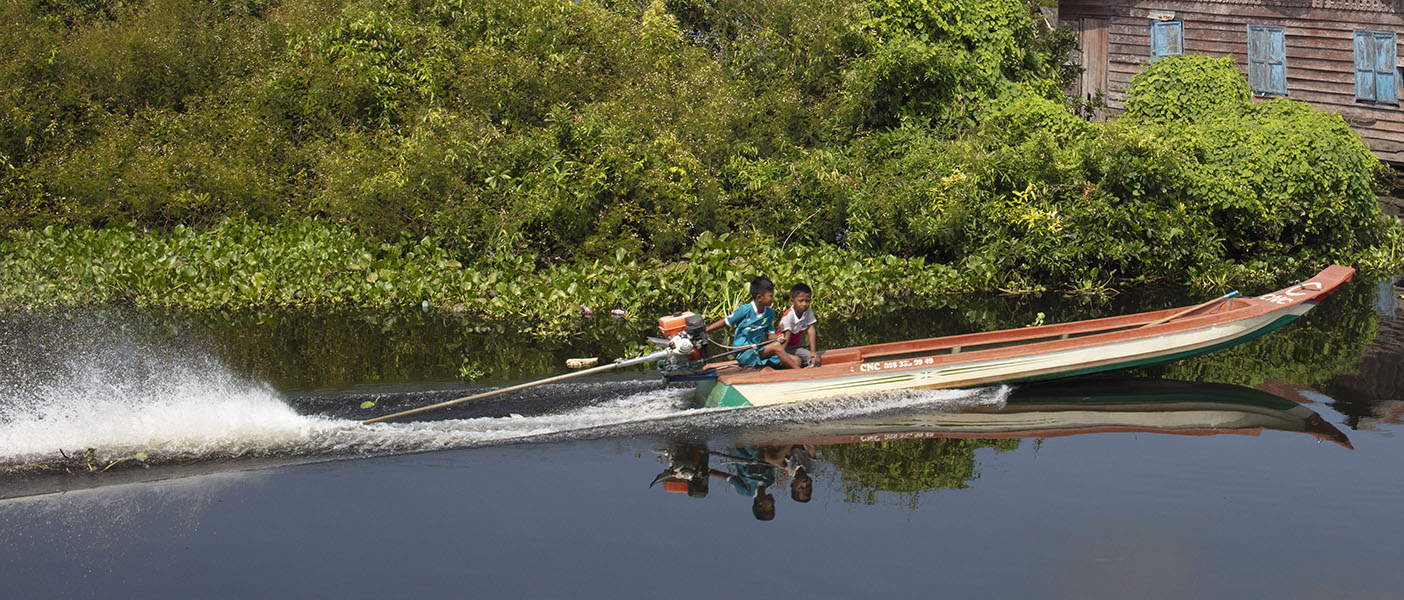 Wild Children in Long Tailed Boat, Tonle Sap, Cambodia.